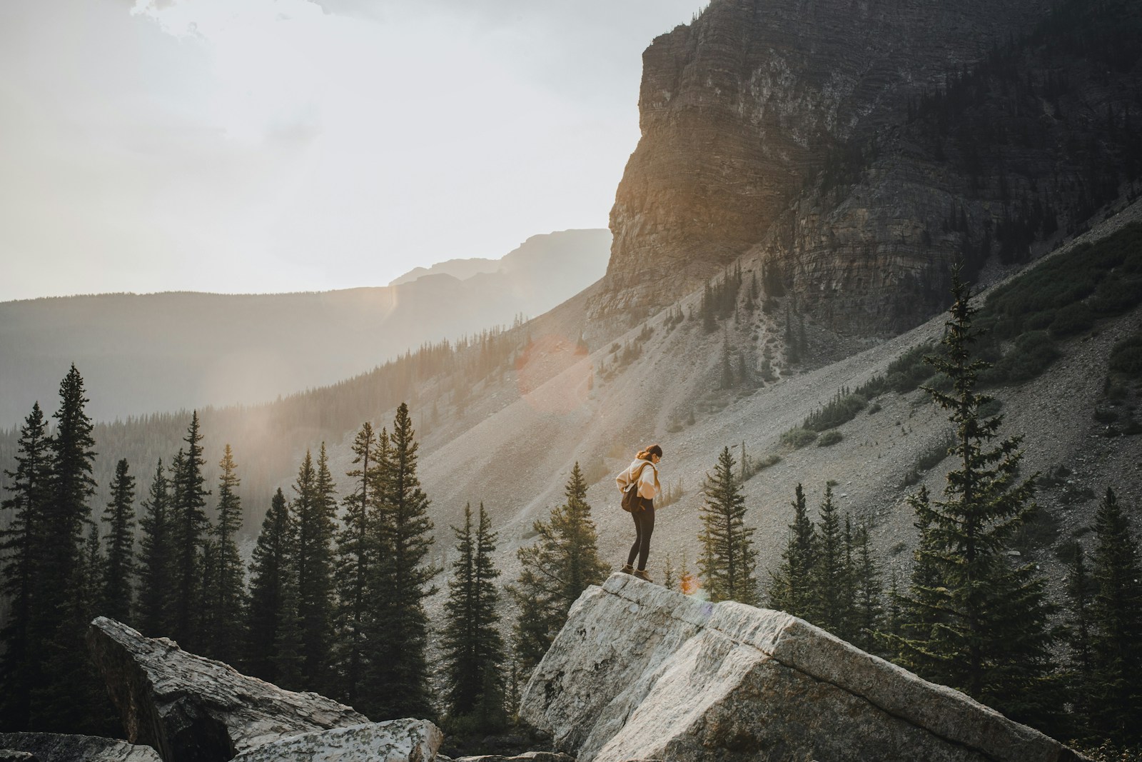 Photo by Hai Phung Hiker admires mountain view at sunset.